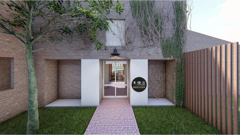 The main entrance: a brick path through a lawn to a white door set in a brick wall