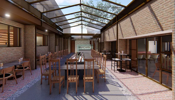 The courtyard bar looking toward the entrance, with a communal table down the centre
